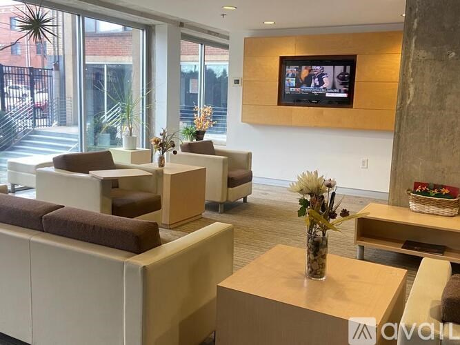 A modern waiting room with a flat screen TV mounted on the wall.