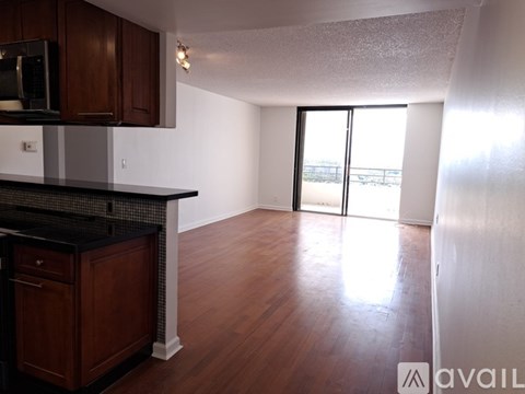 A kitchen with dark wood cabinets and a black countertop.