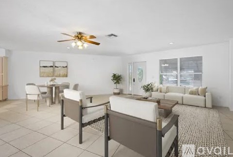 A spacious living room with a dining table and chairs.