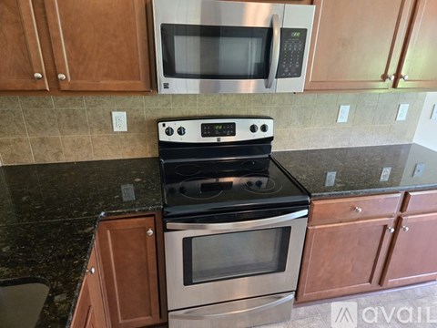 A kitchen with a stove top oven and microwave above it.