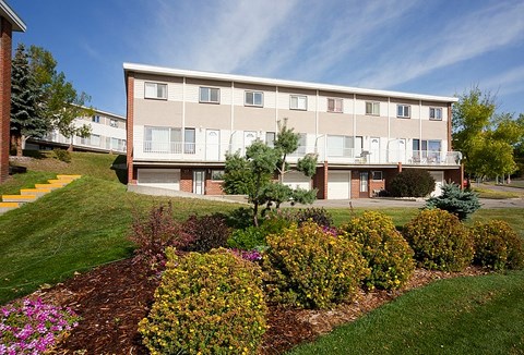 A building with a green lawn in front of it.