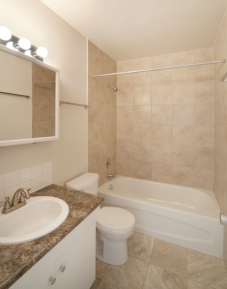 A bathroom with a sink, toilet, and bathtub.