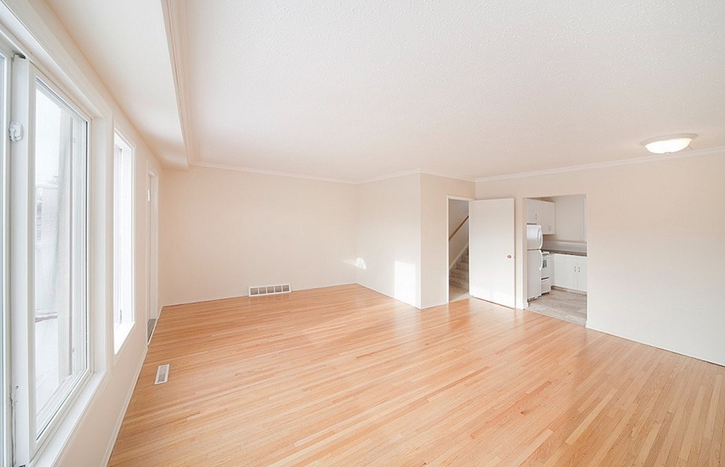 A room with wooden floors and white walls.