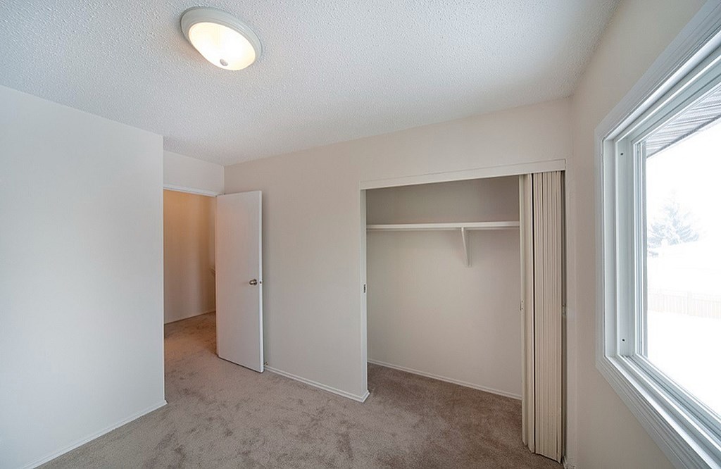 A room with a carpet floor and a window.