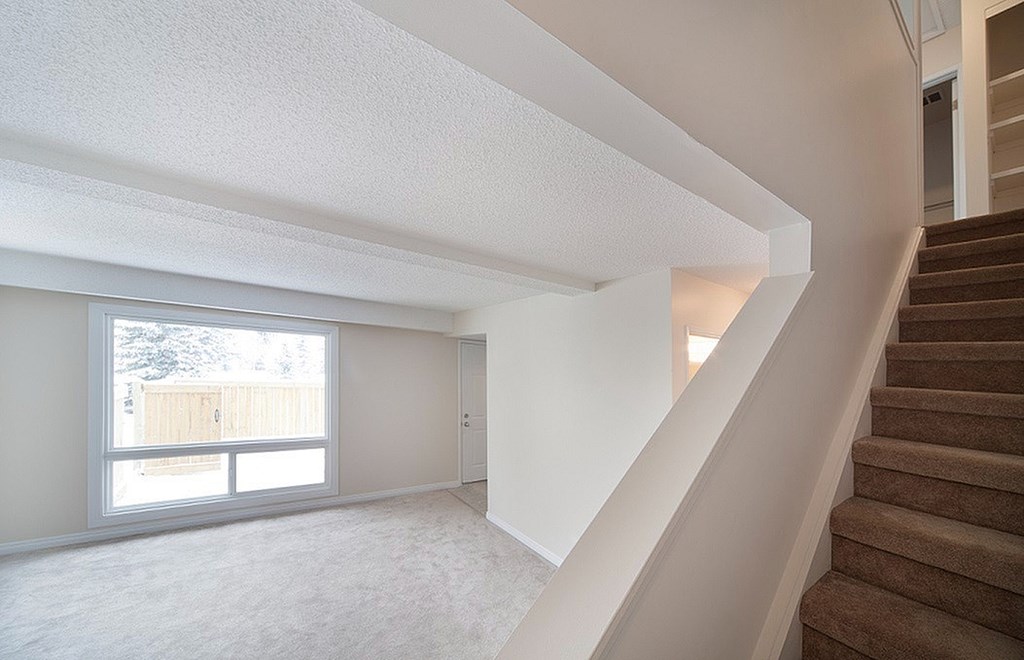 A room with a staircase leading to the upper floor.