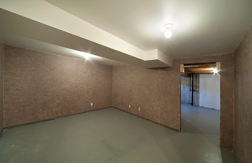 A room with brown walls and a green floor.