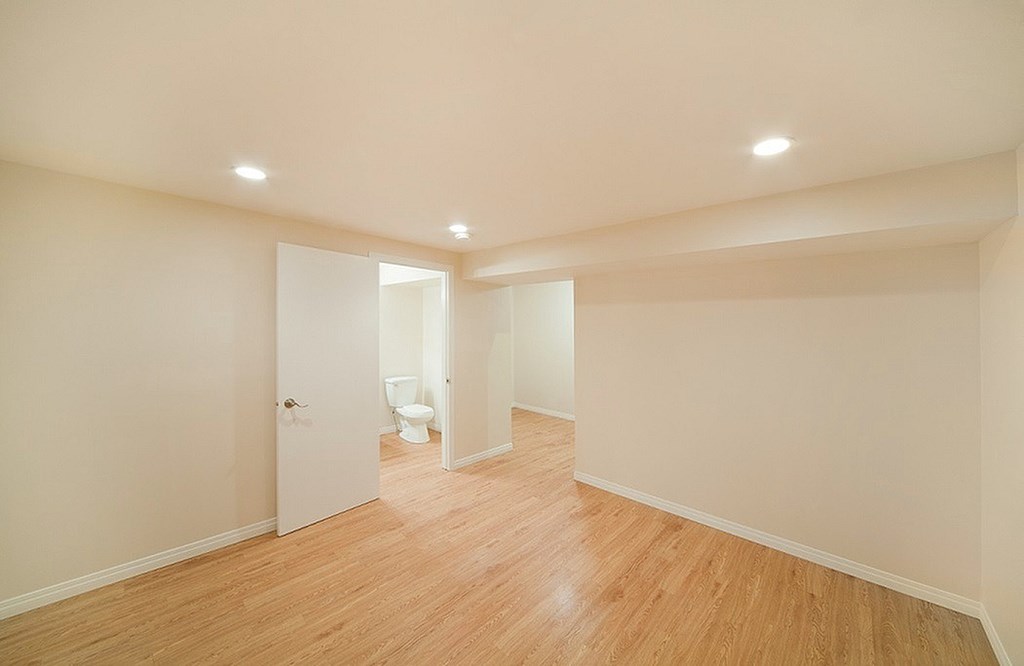 A room with wooden floors and white walls.