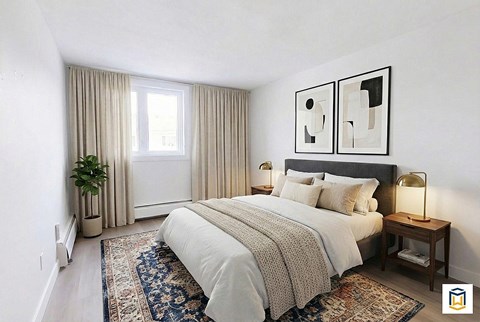 A bedroom with a large bed and two framed pictures on the wall.