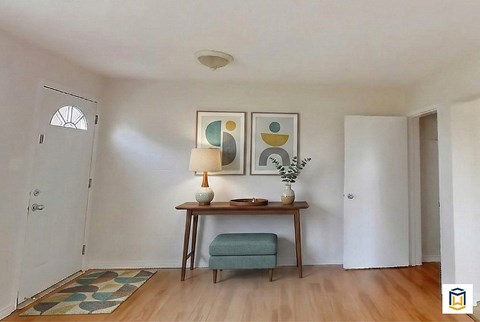 A spacious basement with a staircase, a white refrigerator, and a blue cabinet.