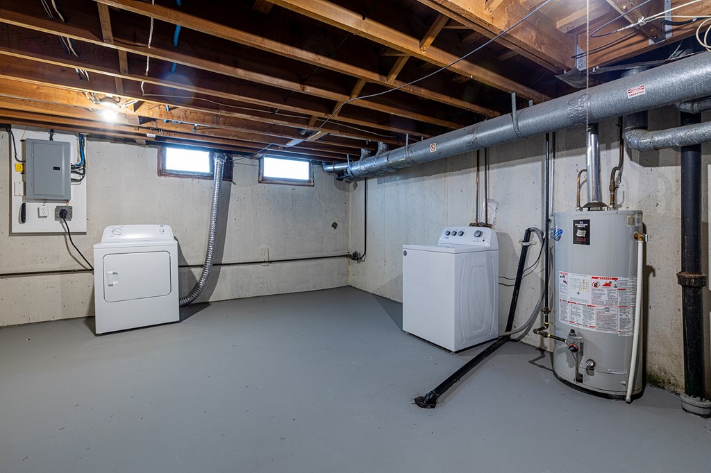 A room with a furnace, air conditioner, and a water heater.