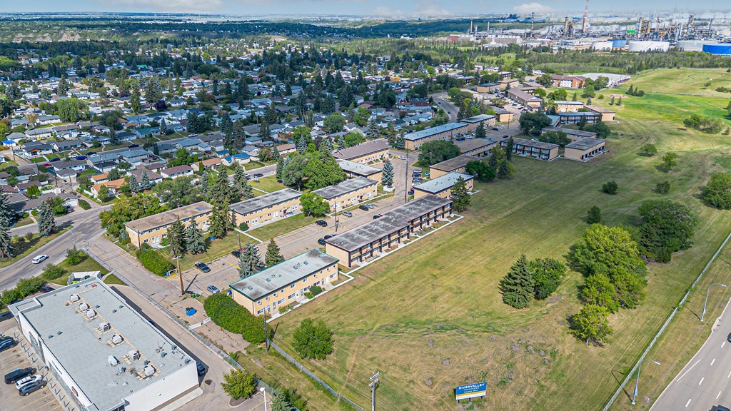 A bird's eye view of a city with buildings, roads, and trees.