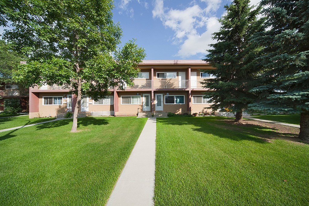 A building with a green lawn in front of it.