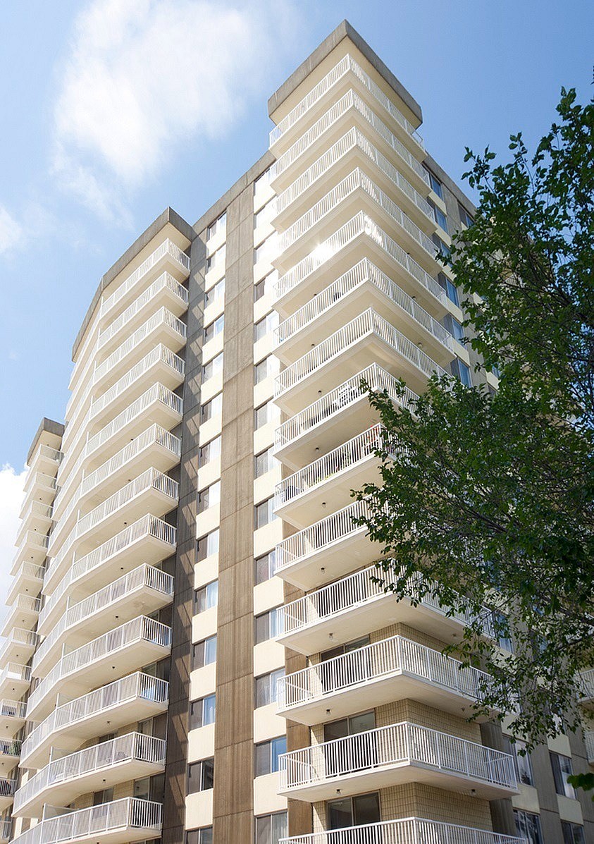 A tall building with balconies on each floor.