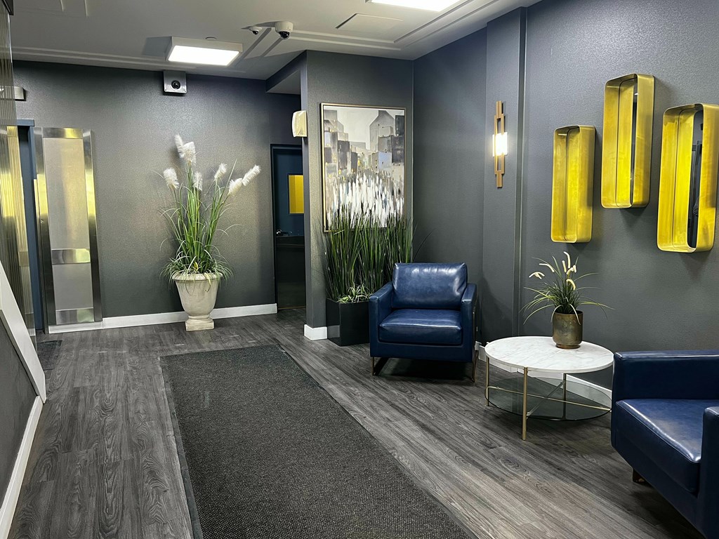 A blue chair sits in a room with a grey carpet.