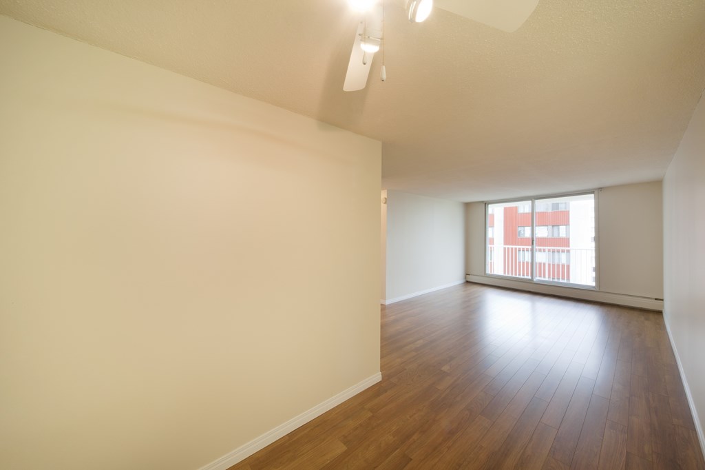 Empty room with wooden floor and white walls.