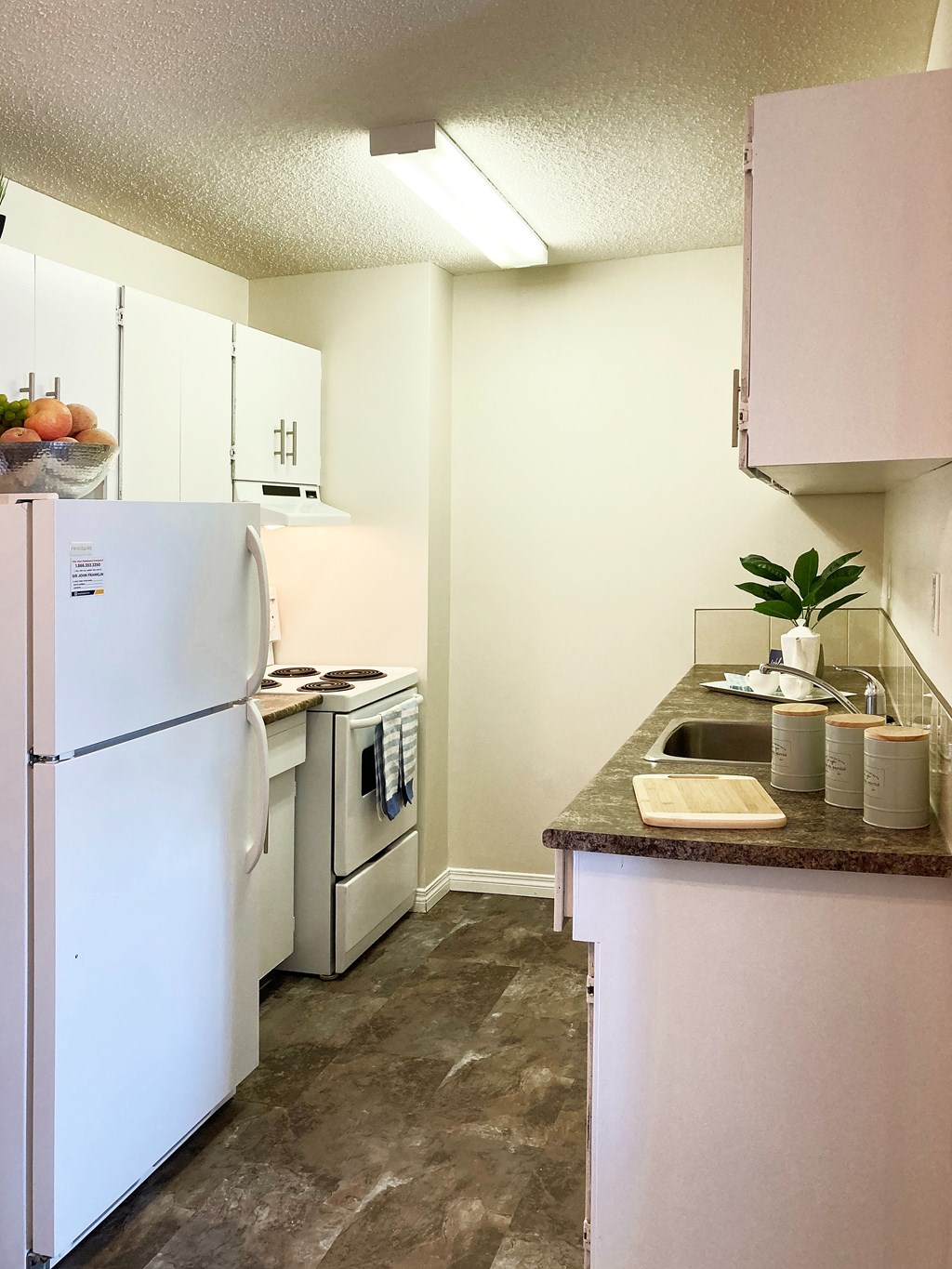 A kitchen with a white refrigerator and a white oven.