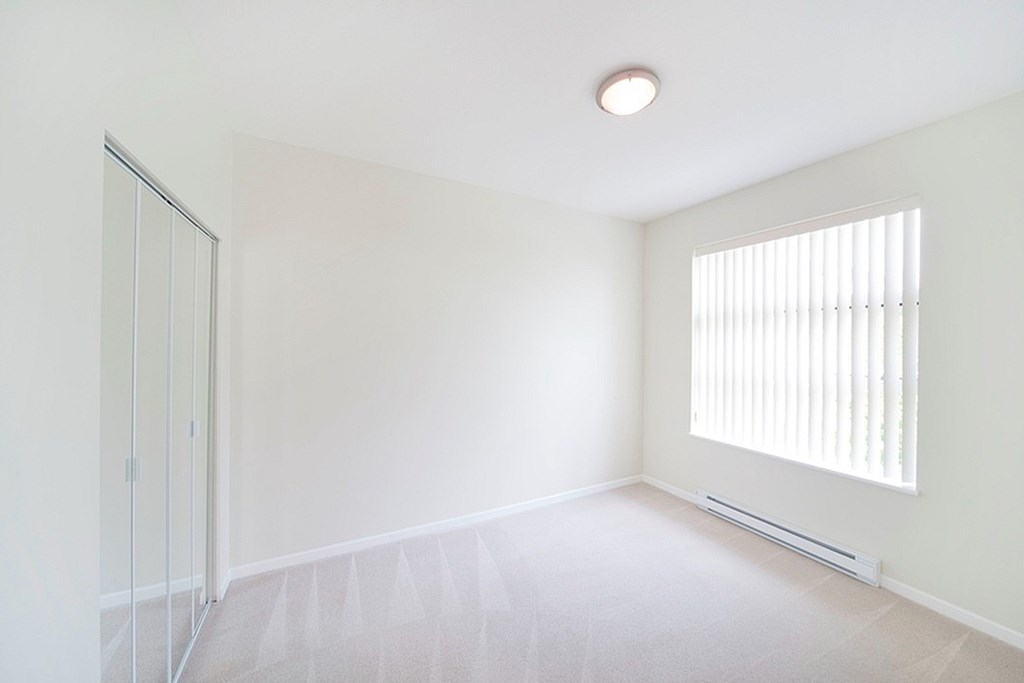 A white room with a window and a door.