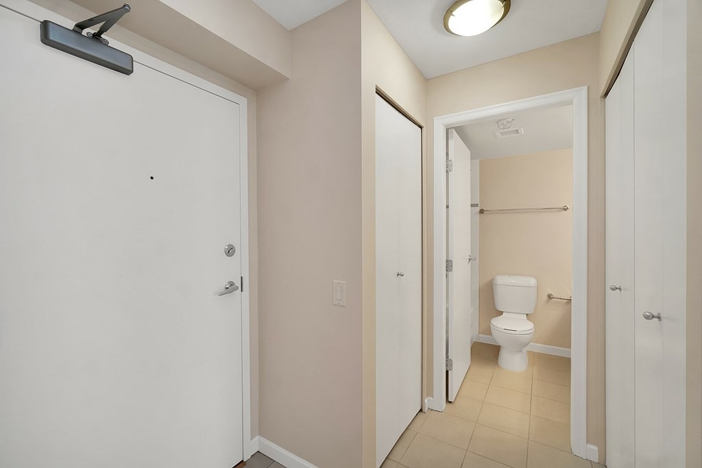 A white door with a black handle is on the left.