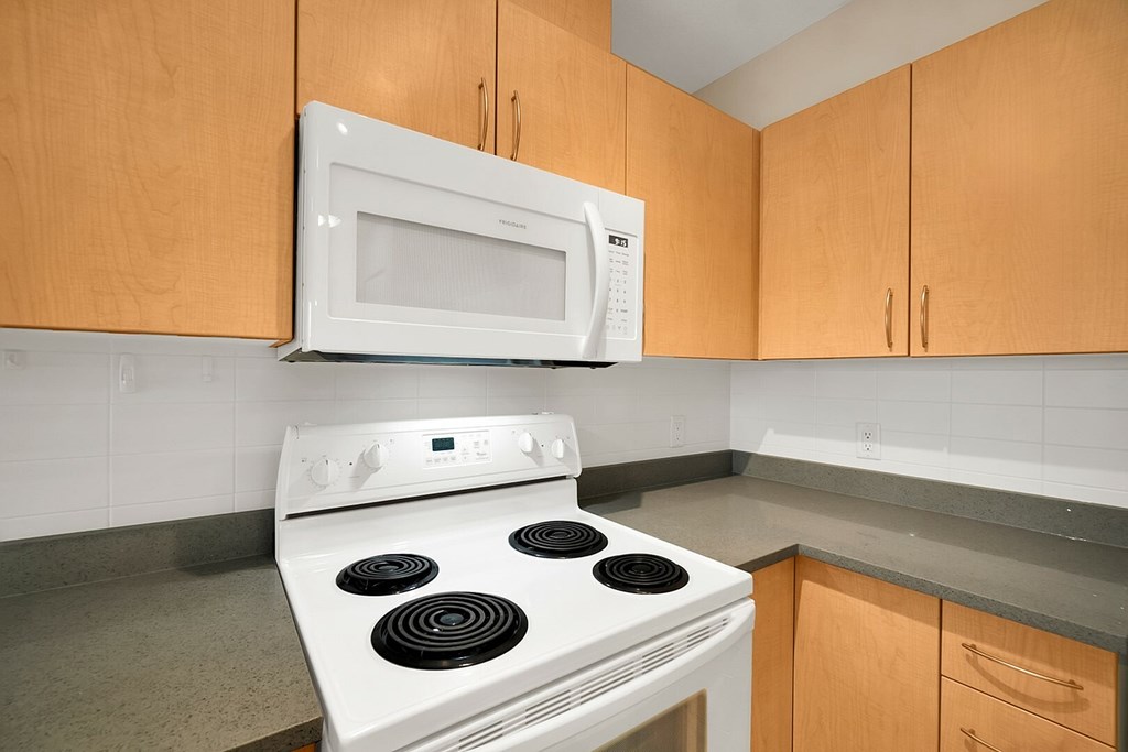 A white stove and microwave in a kitchen.