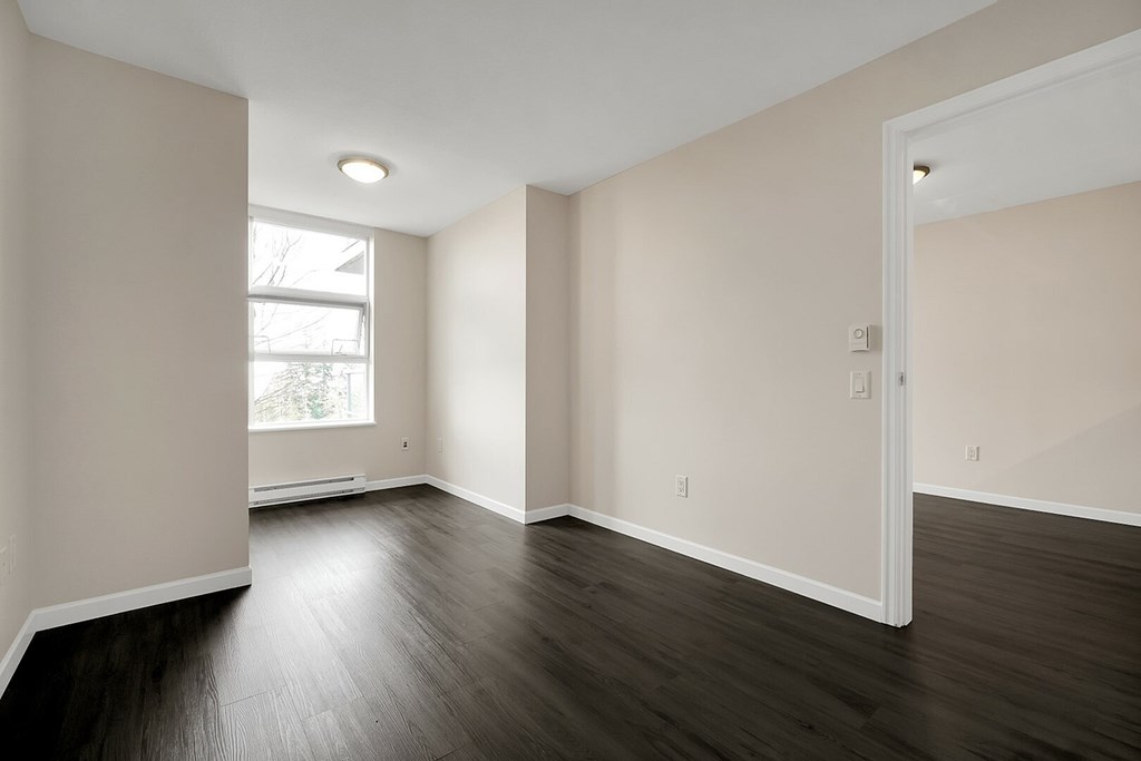 A room with wooden floors and white walls.