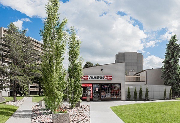 A building with a sign that says "Lavalle Foods" is surrounded by trees and bushes.