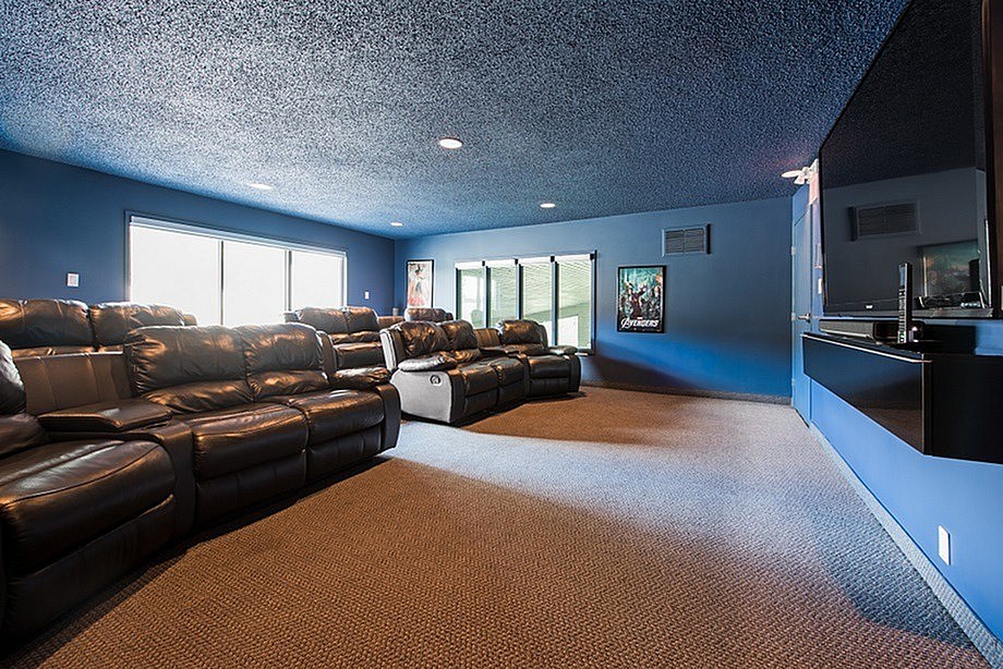 A sparsely furnished room with a carpeted floor and a large window.