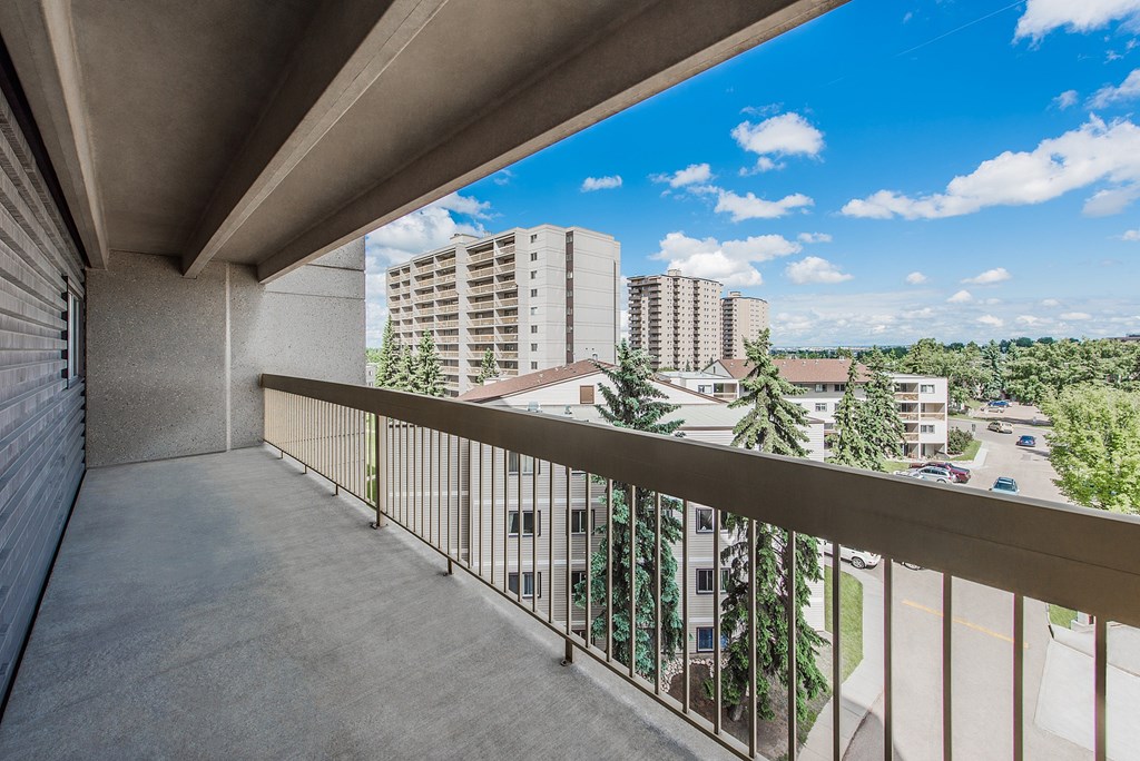 A balcony with a view of a residential area.
