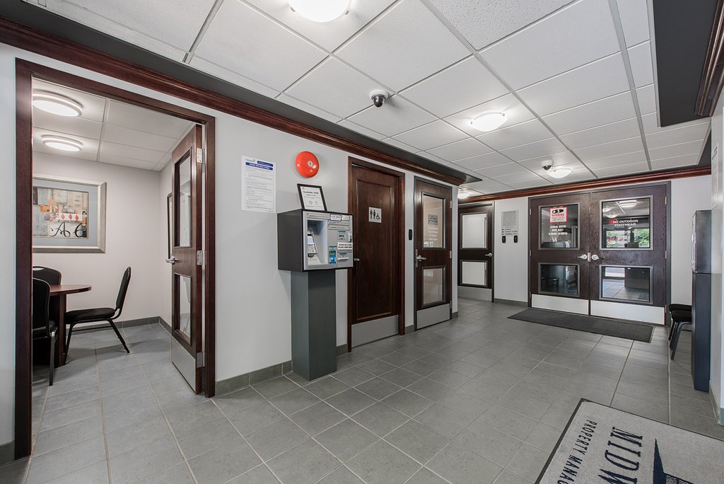 A hallway with a red circle sign on the wall.