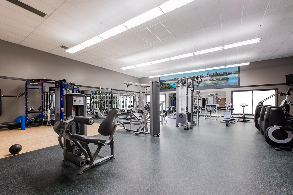 A gym with a variety of equipment including a leg press machine.