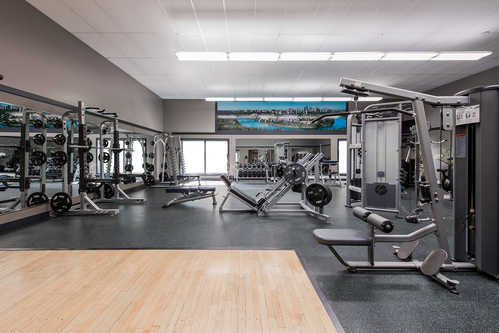 A gym with a variety of equipment including weights and machines.