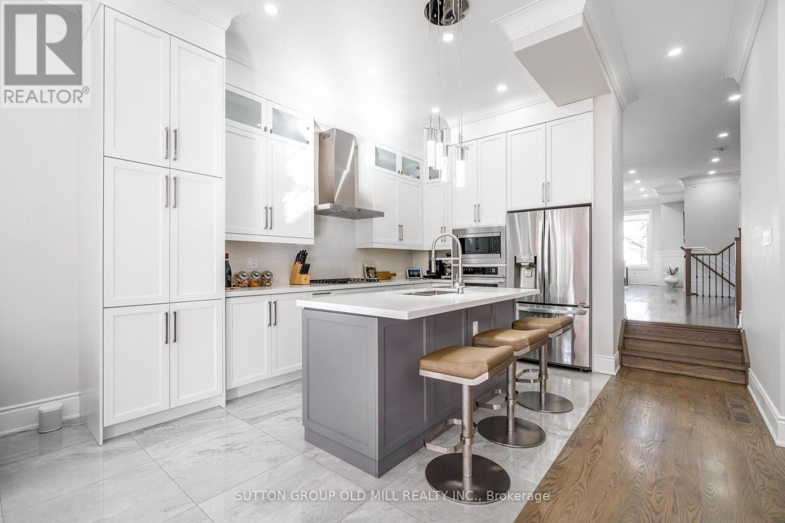 A modern kitchen with white cabinets and a central island.