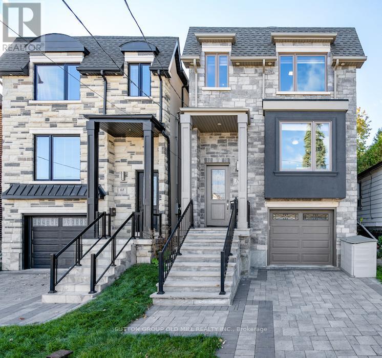 A house with a stone facade and a black garage door.