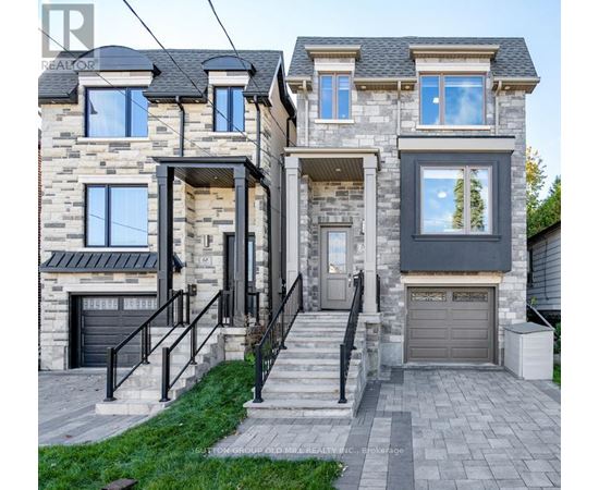 A house with a stone facade and a black garage door.