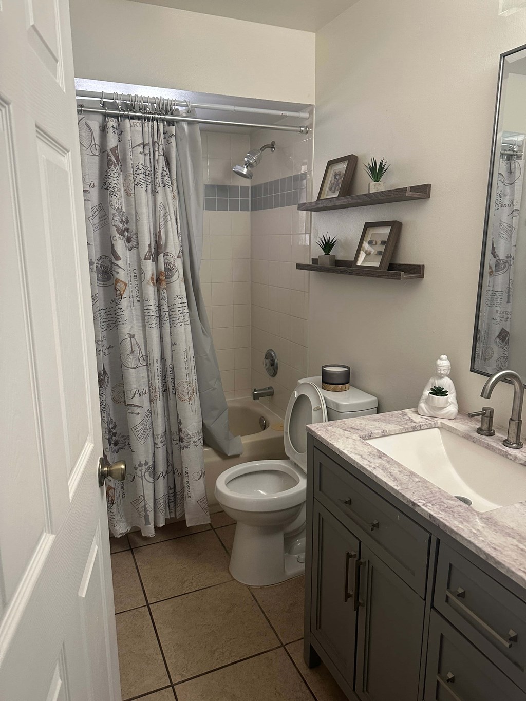 A bathroom with a toilet, sink, and shower.