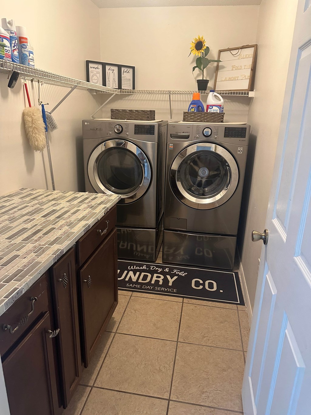 A laundry room with two front loading washing machines.
