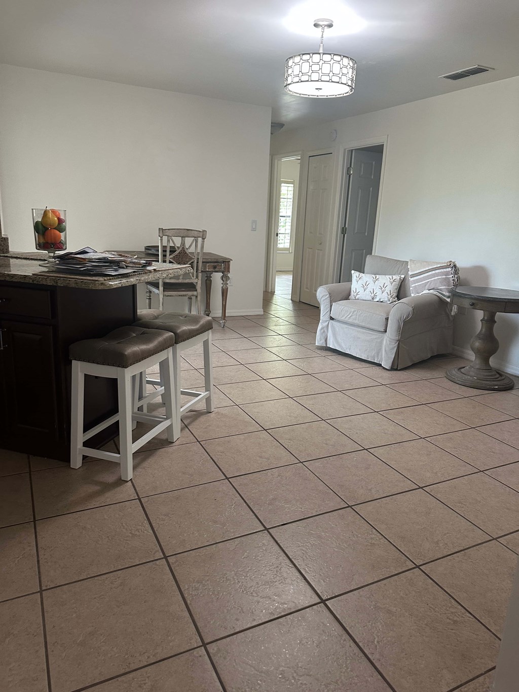 A kitchen with a table and chairs.