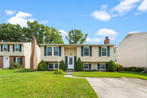 A house with a green lawn and a clear blue sky.
