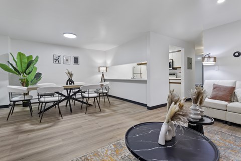 A living room with a black coffee table and a white sofa.