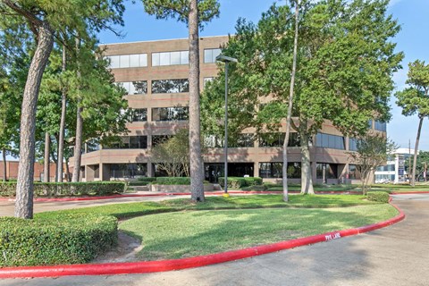 A large building with a red curb in front of it.