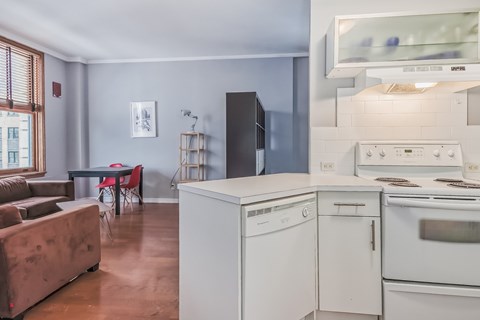 A kitchen with a white oven and a white dishwasher.