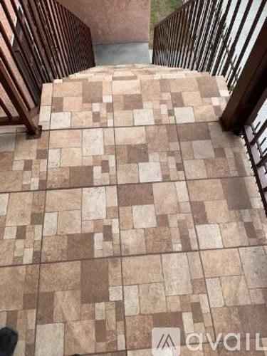 A tiled staircase with a metal railing.