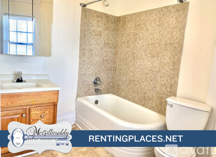 A white shelving unit with the text "McGillicuddy RENTAL PROPERTIES" and "available" on the bottom right.