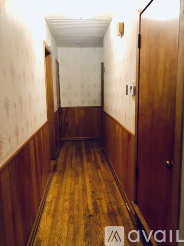 A long hallway with wood floors and walls.