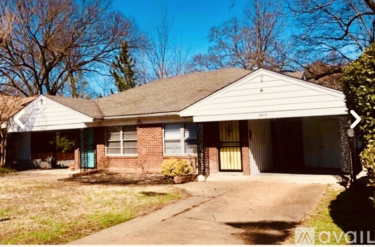 A house with a white roof and a brick wall is for sale.