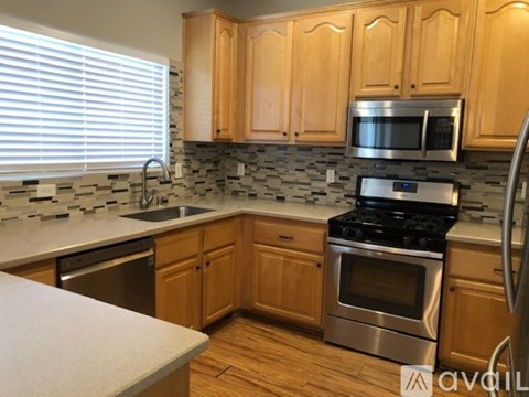 A kitchen with wooden cabinets and a stove top oven.