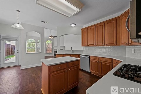 A kitchen with wooden cabinets and a white countertop.