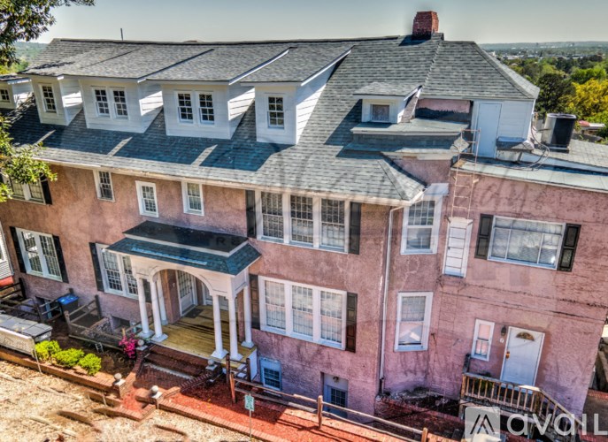 A large house with a balcony and a front porch.