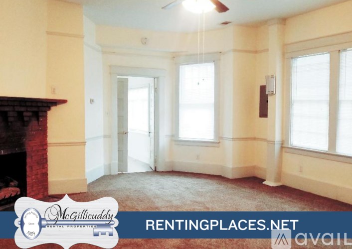 A room with wooden floors and a ceiling fan.