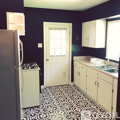 A black and white tiled kitchen floor.
