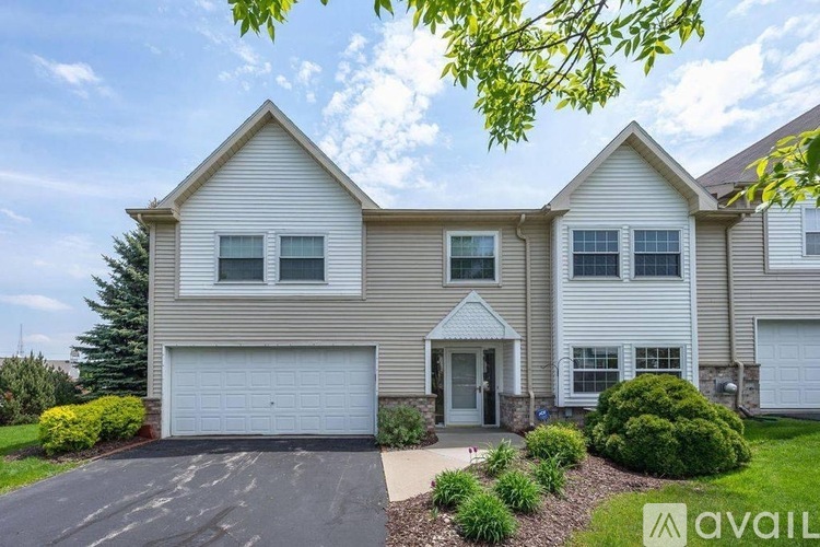 A two-story house with a garage is available for sale.